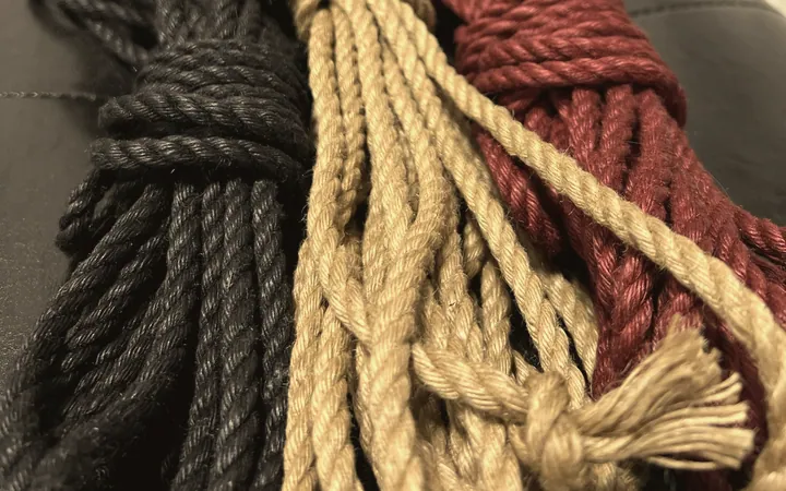Coils of black, natural and burgundy rope.