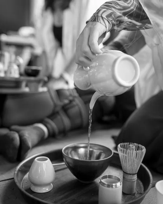 Tea poured into a bowl during a tea ceremony at the party.